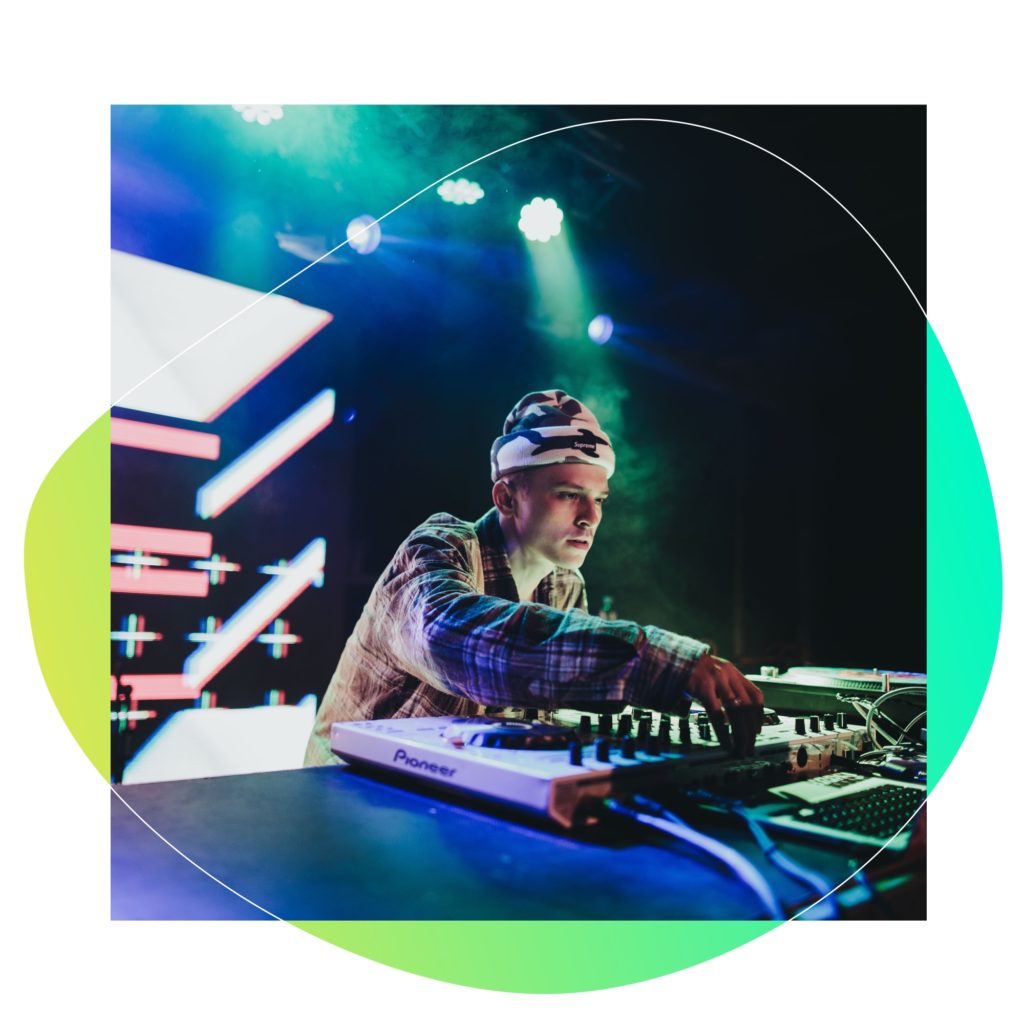 A DJ performs and plays his song on stage.