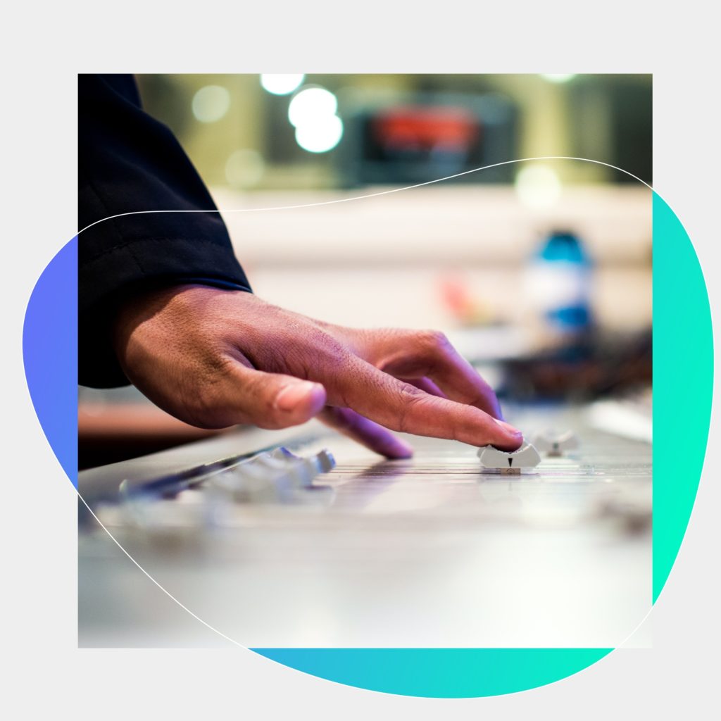 A DJ on stage with his equipment